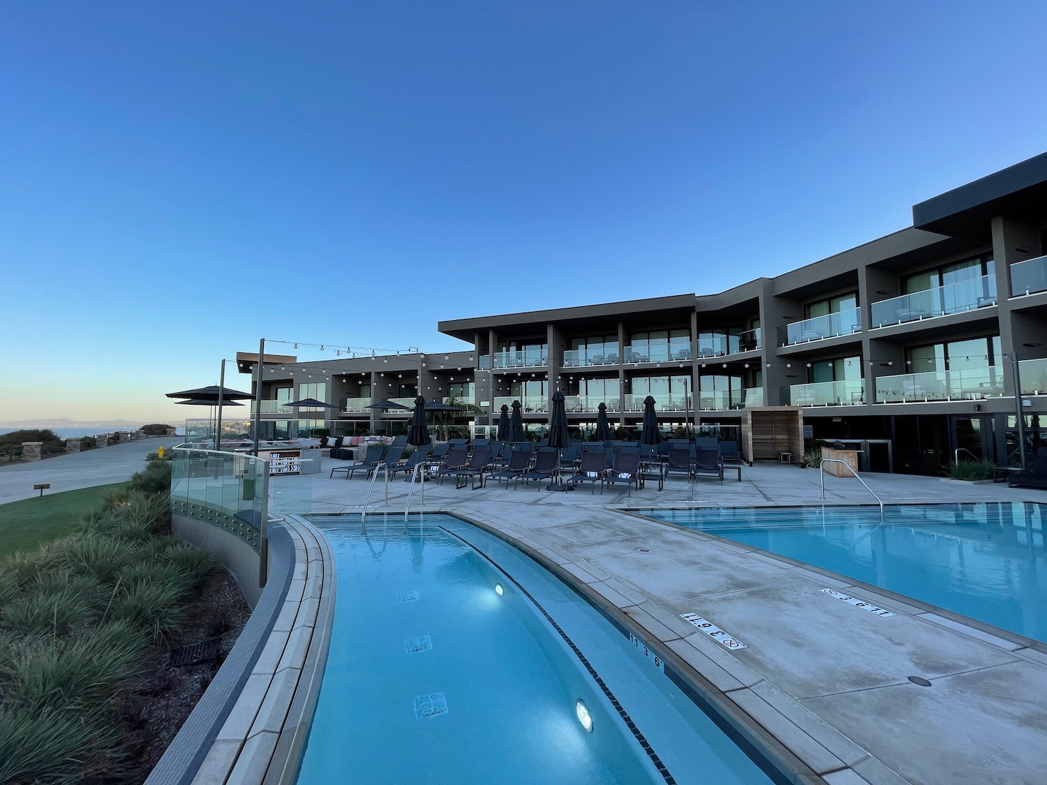 a pool and a building with a pool in the background