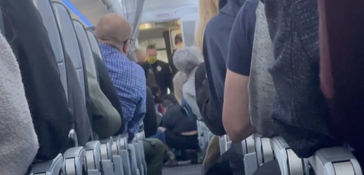 a group of people sitting on an airplane