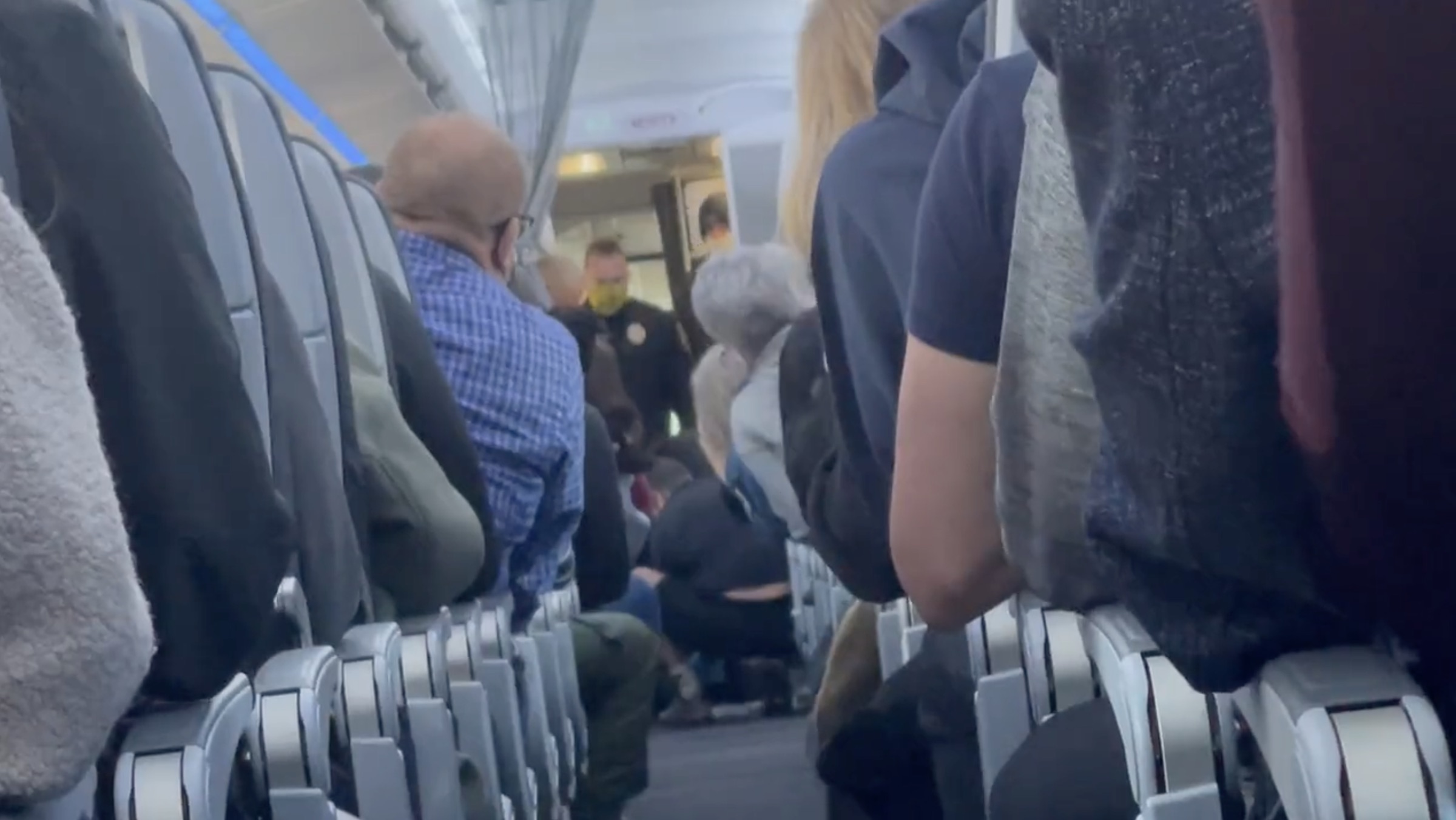 a group of people sitting on an airplane