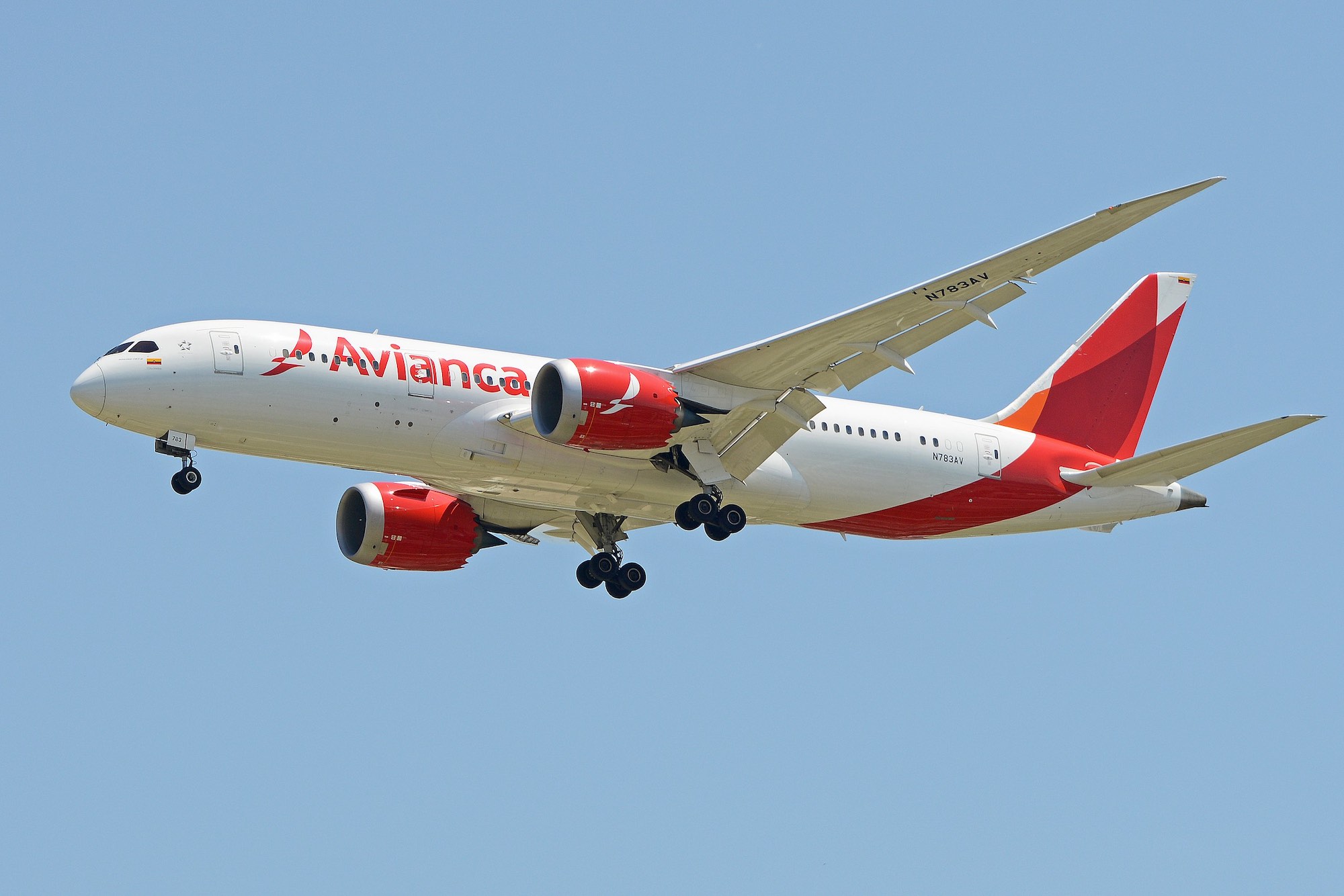 a white and red airplane in the sky