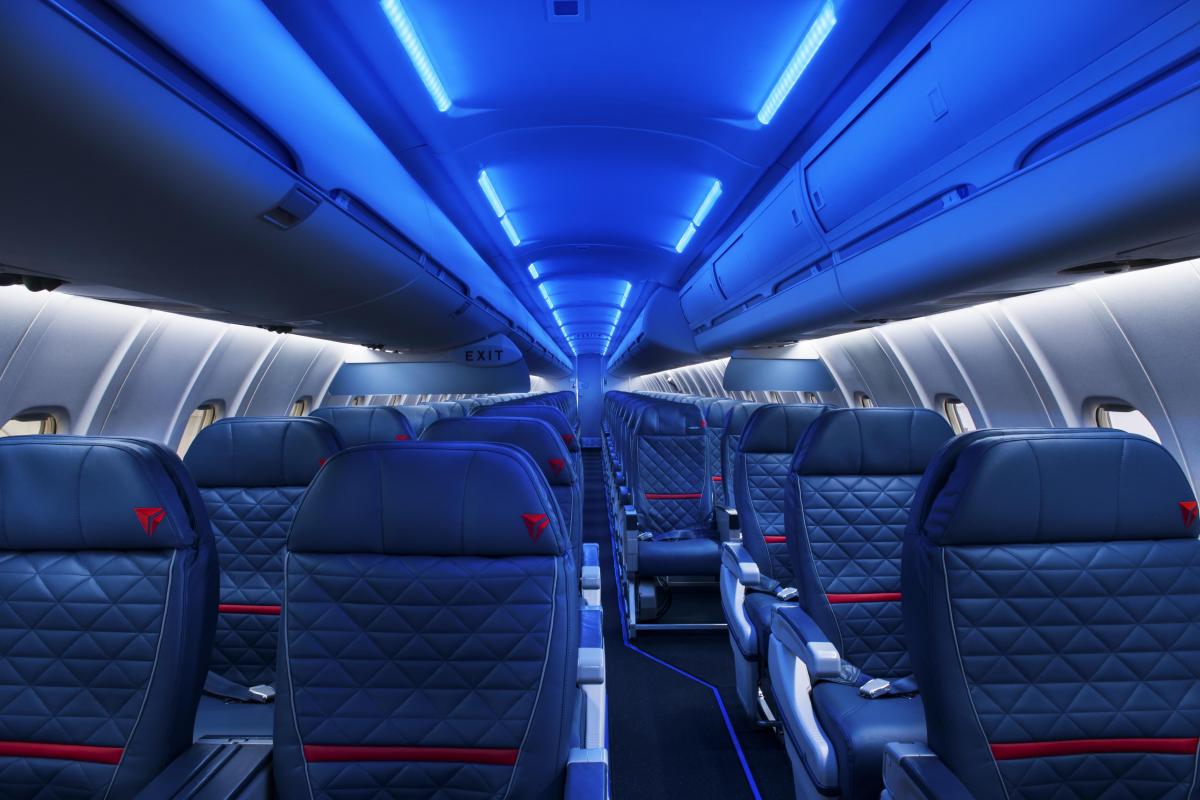 the inside of an airplane with blue lights