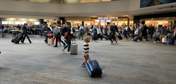 a group of people walking in an airport