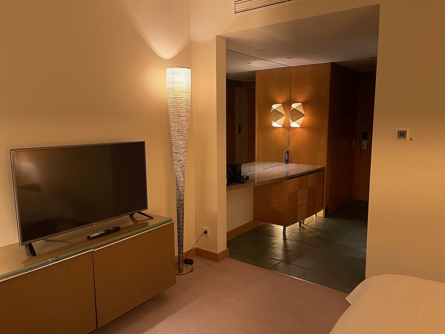 a room with a tv and a mirror