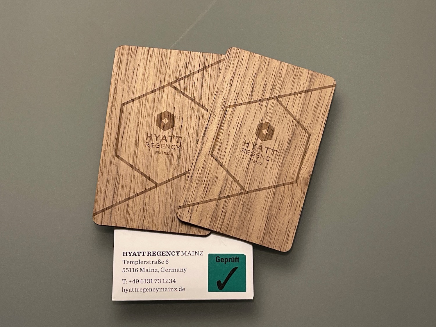 a wooden business cards with a green and white card