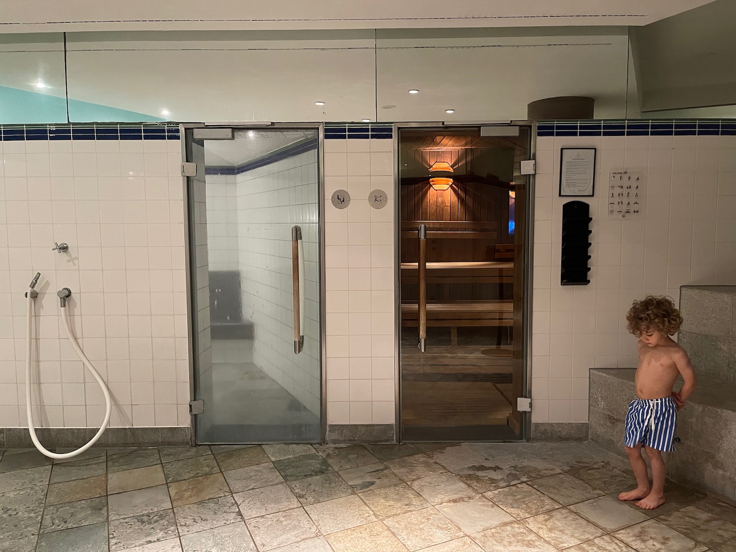 a child standing in a room with a sauna
