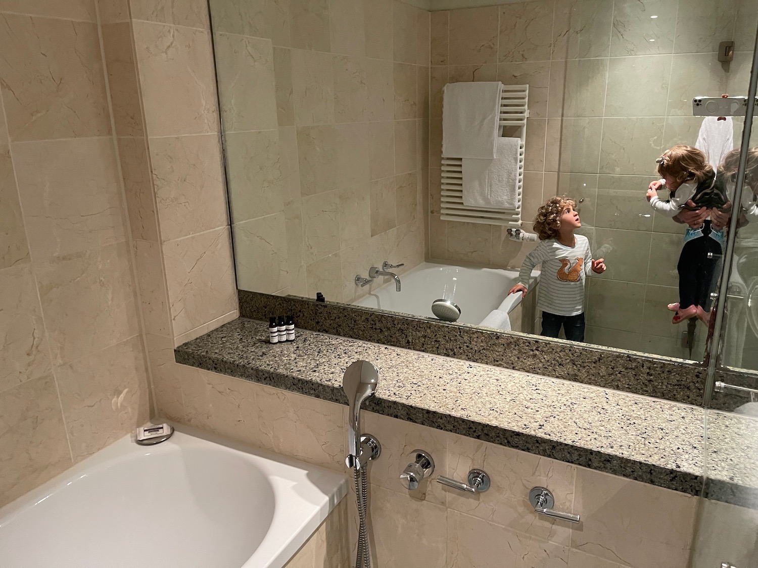 a boy taking a selfie in a bathroom