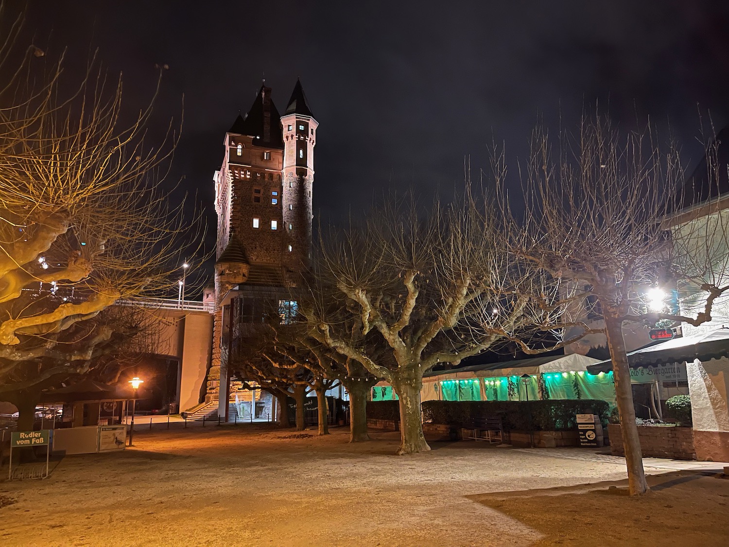 a building with trees and lights at night