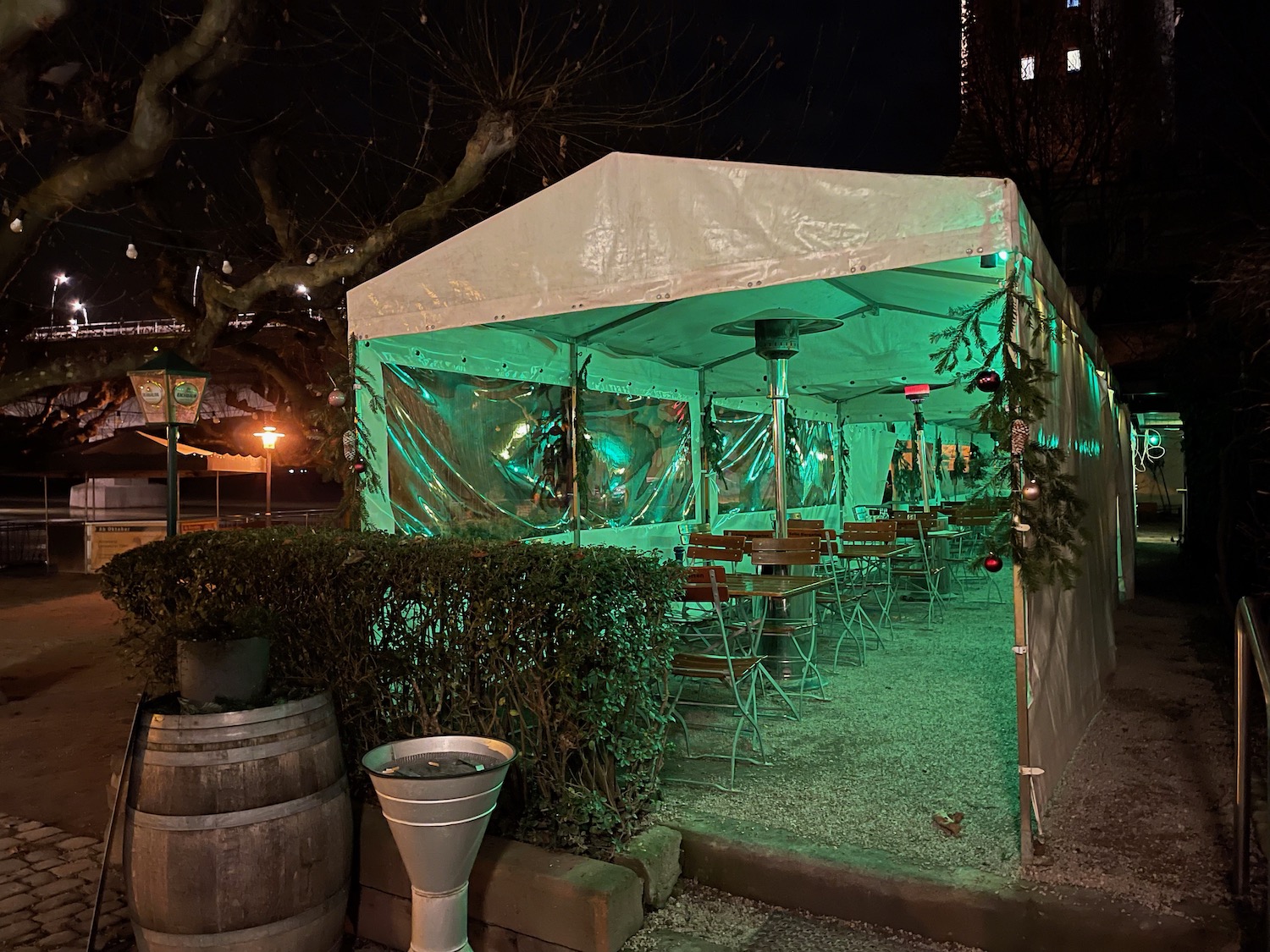 a tent with tables and chairs in green lights