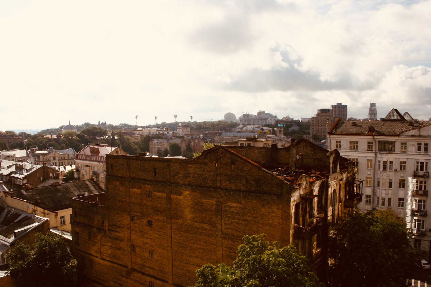 a large brick building with a city in the background