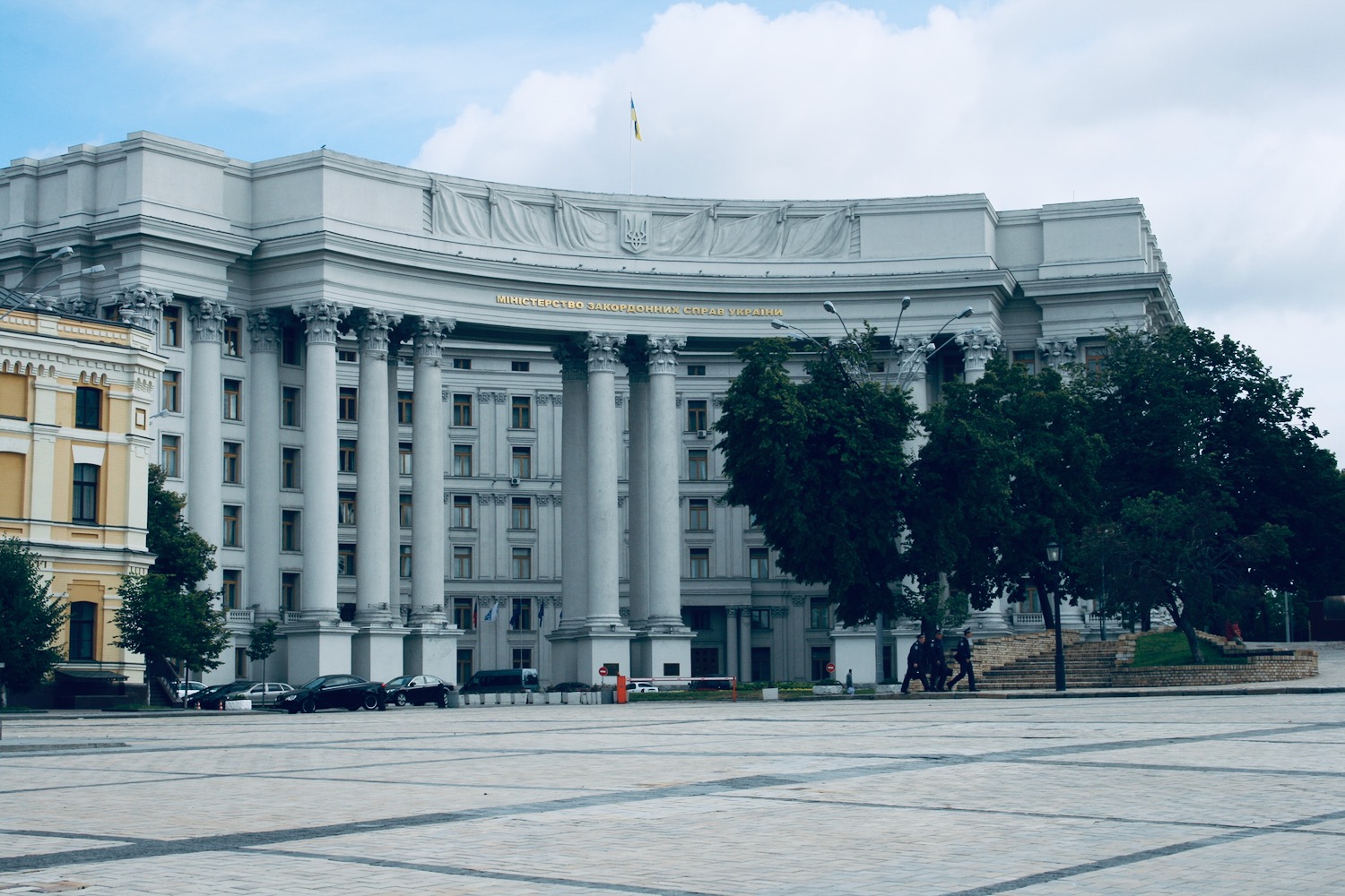 a large white building with columns and a stone walkway