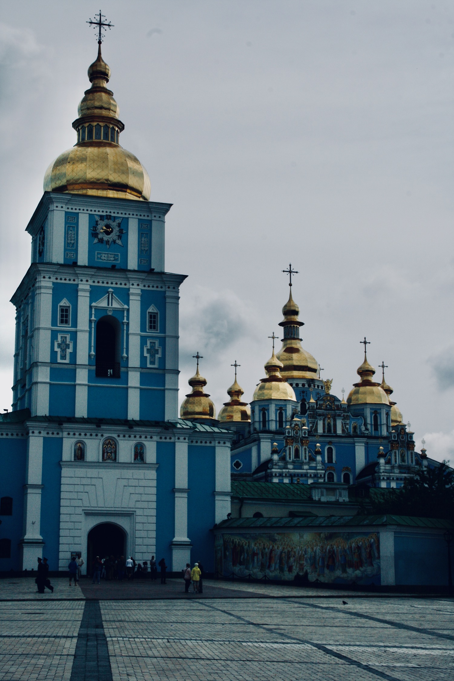 a blue and white building with gold domes
