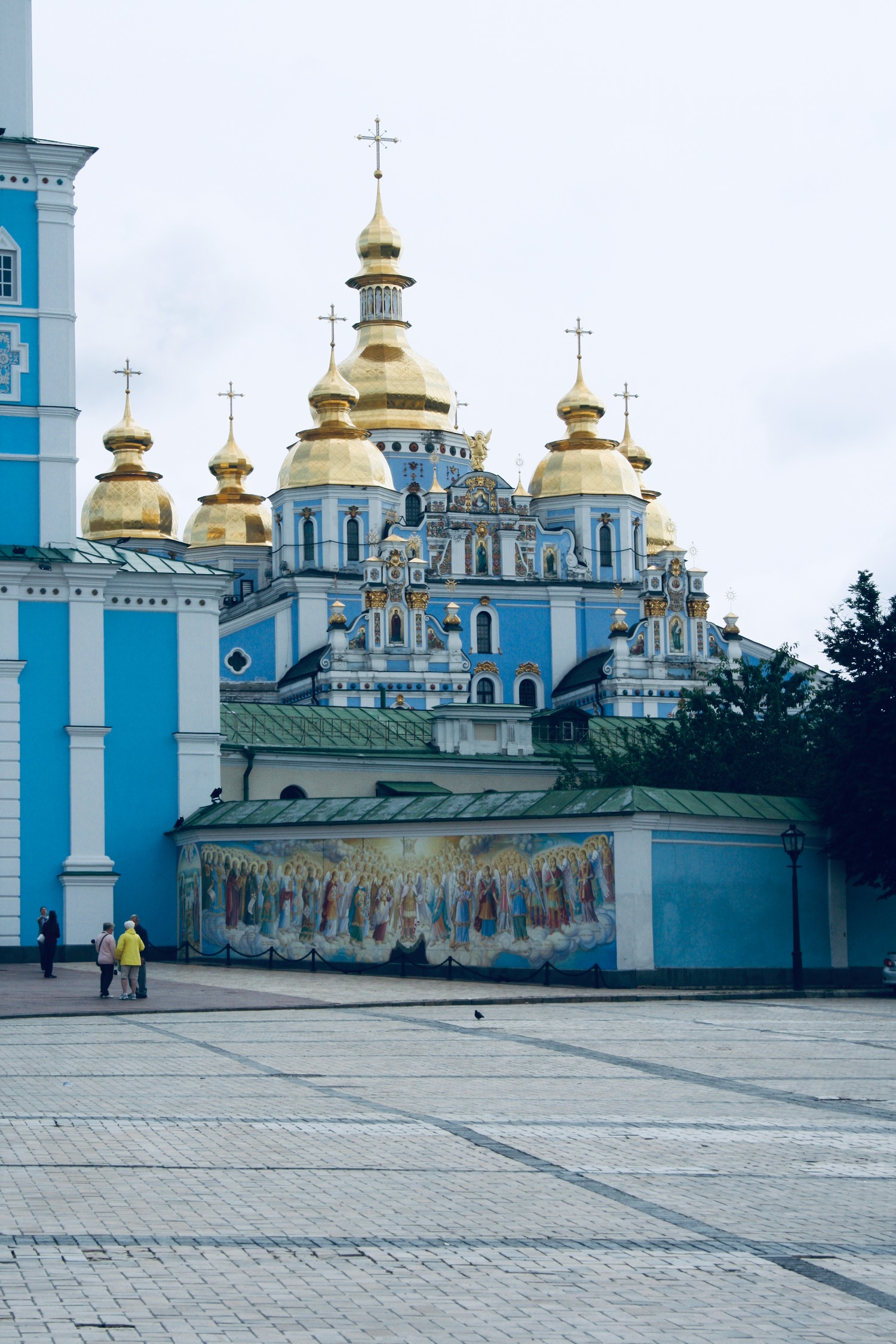 a blue and white building with gold domes with St. Michael's Golden-Domed Monastery in the background