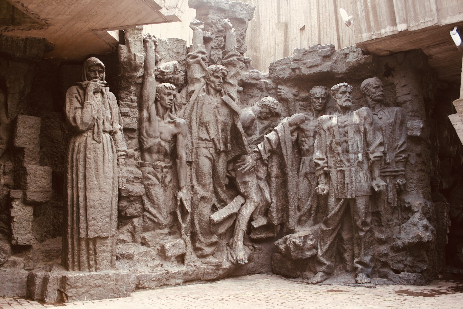 a stone sculpture of people in a row