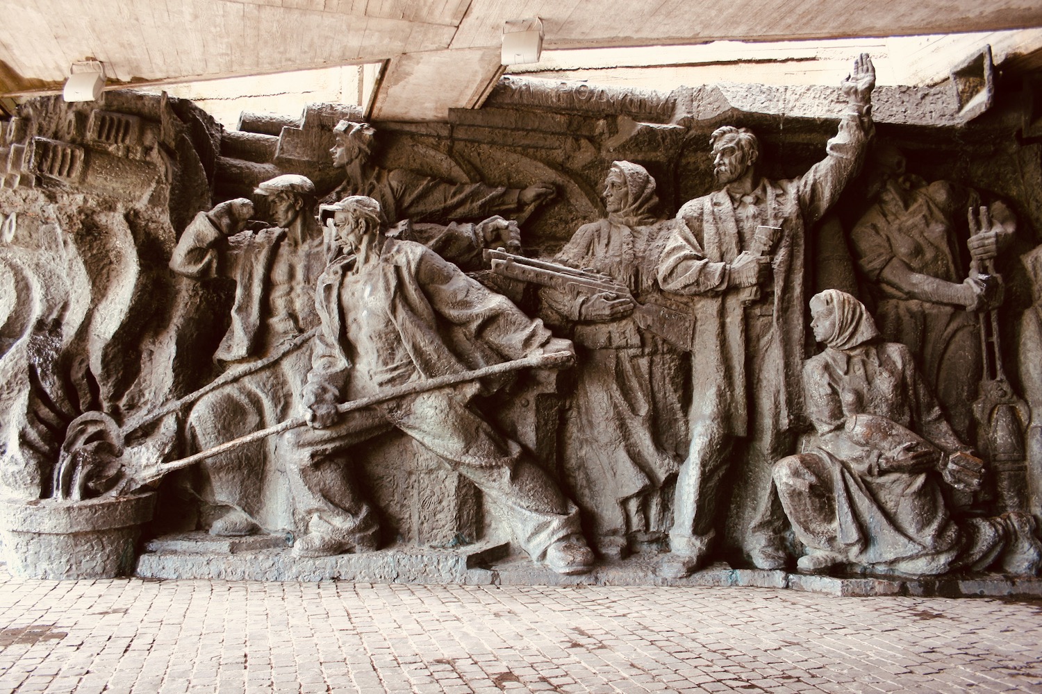 a stone sculpture of people holding guns
