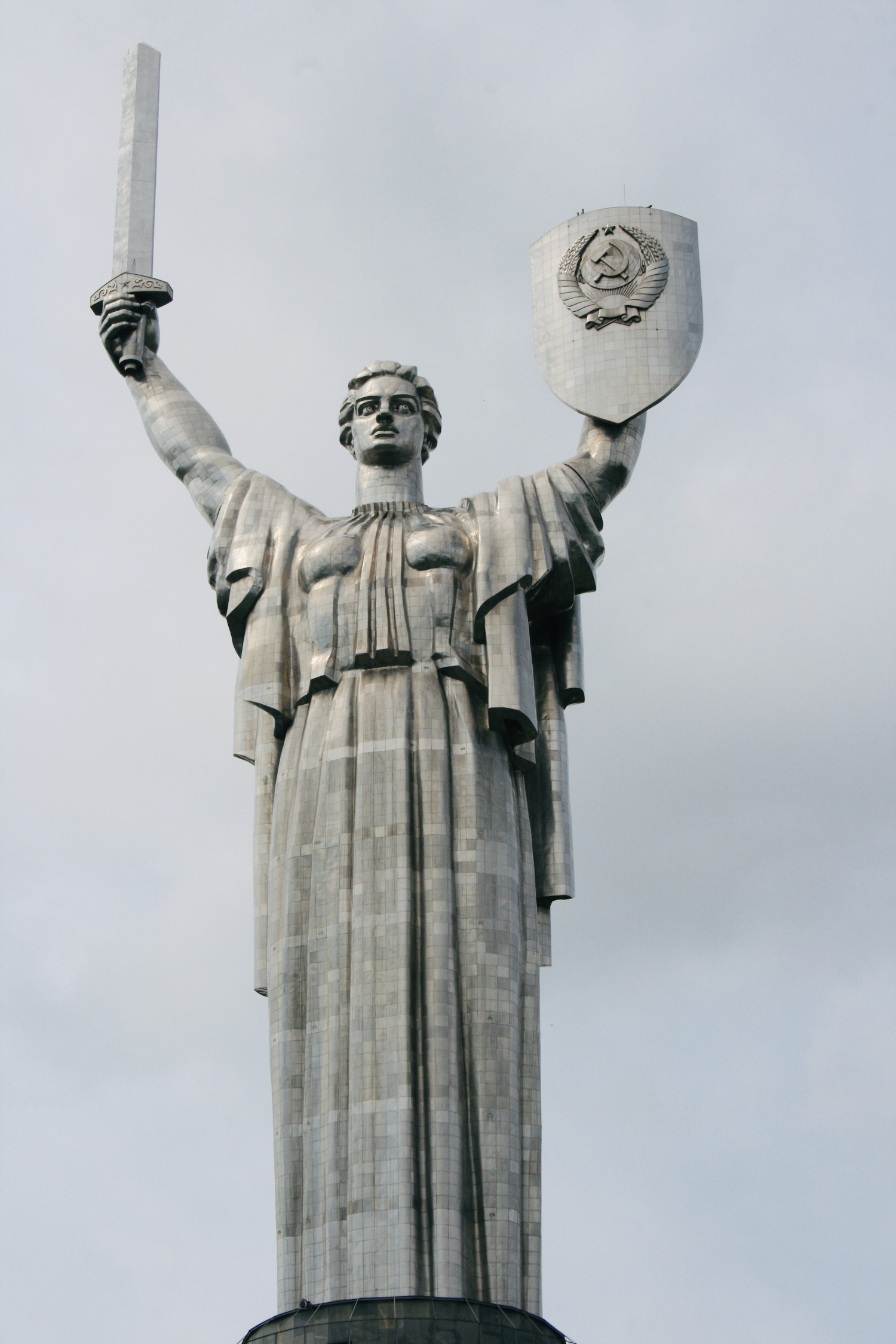 a statue of a woman holding a sword and shield