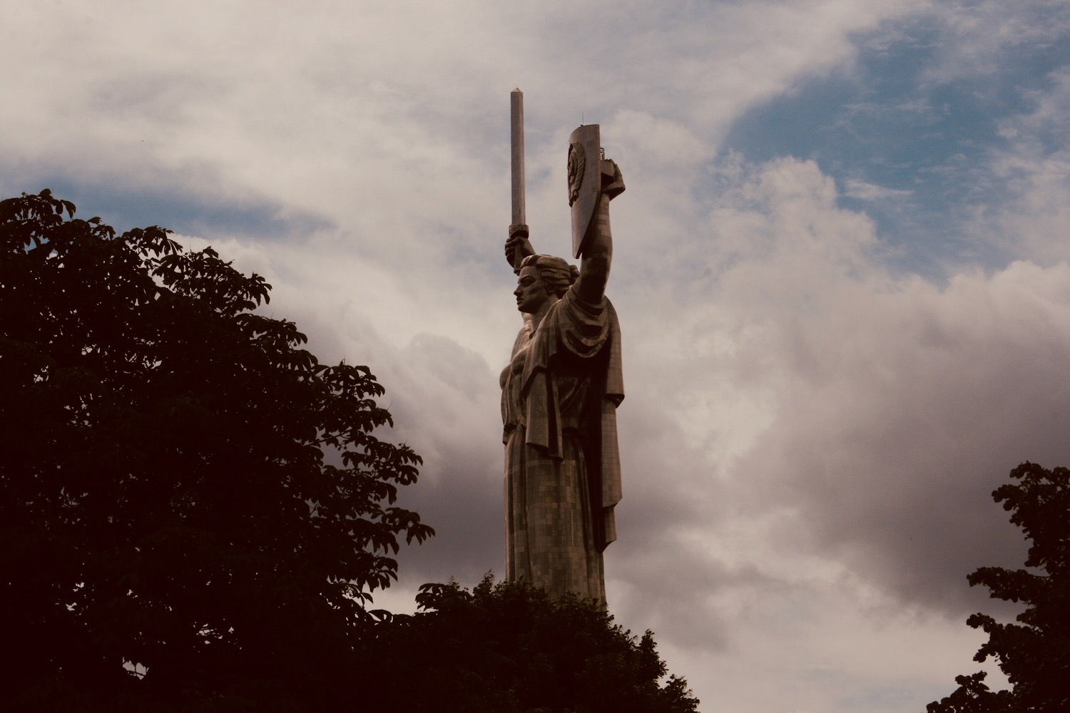 a large statue of a woman holding a shield and a shield