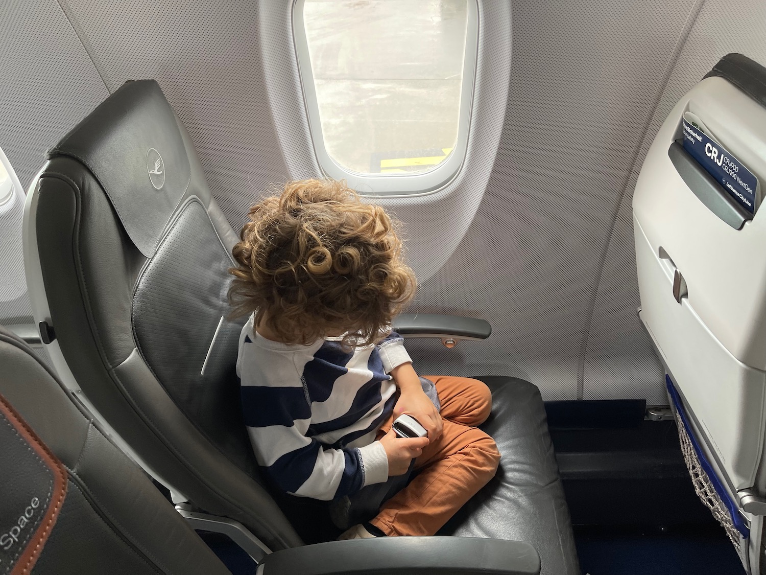 a child sitting in an airplane seat