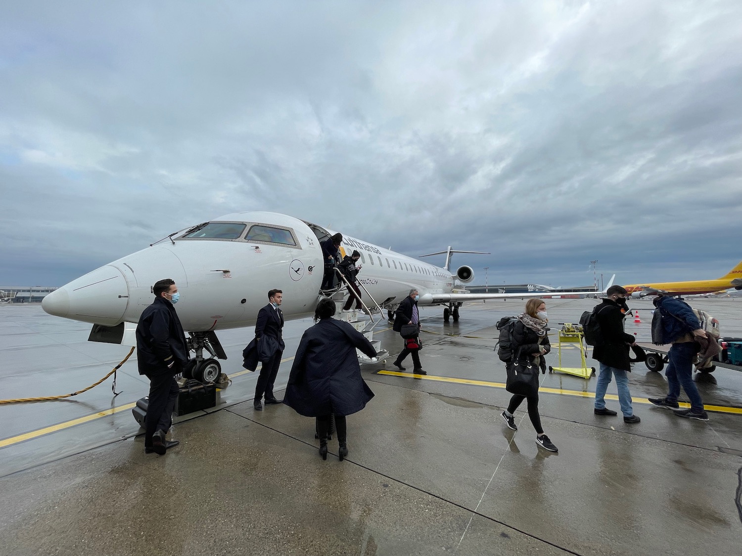 a group of people walking by an airplane