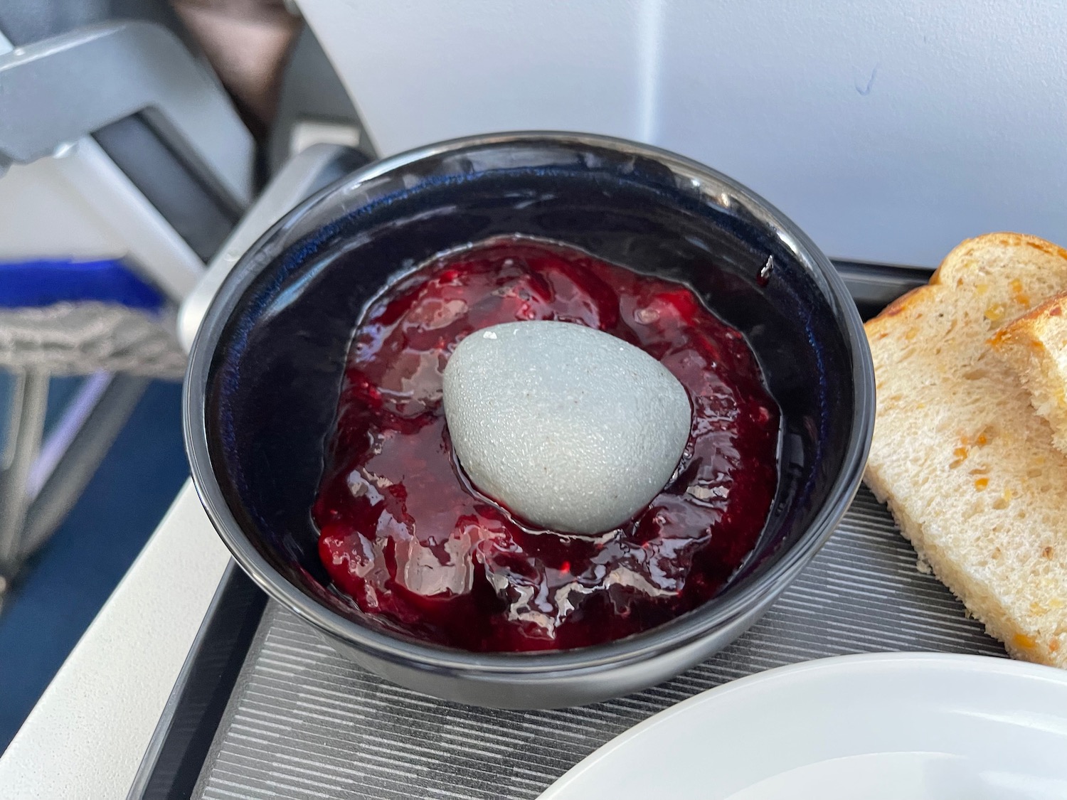 a bowl of jam with a white object on top