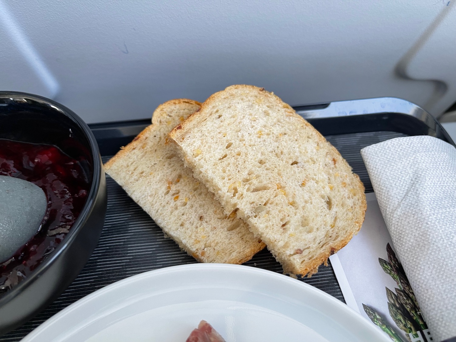 a plate of jam and bread on a tray