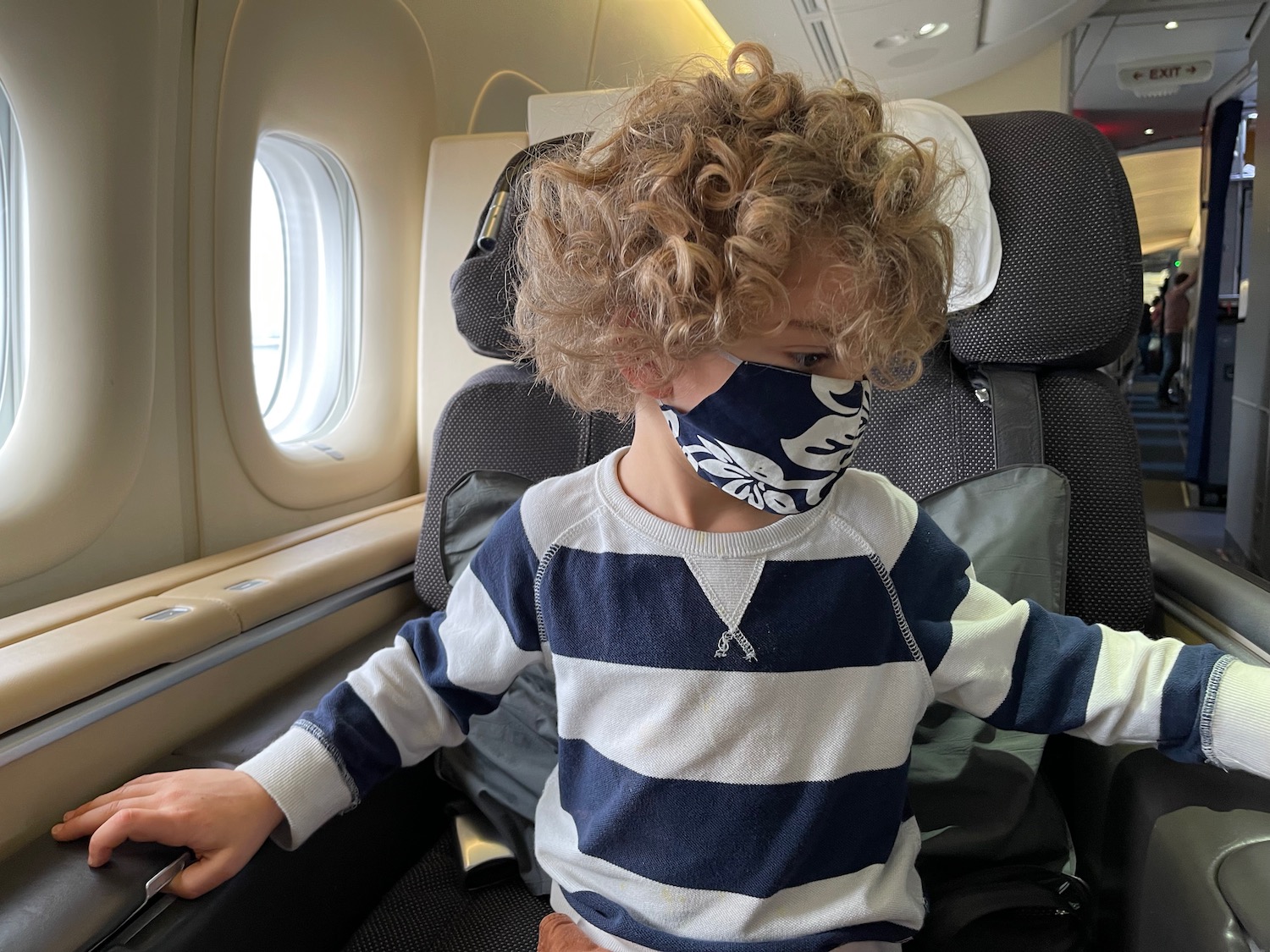 a child wearing a mask on a plane