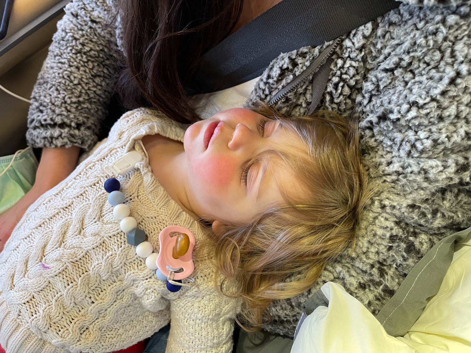 a child sleeping in a car seat