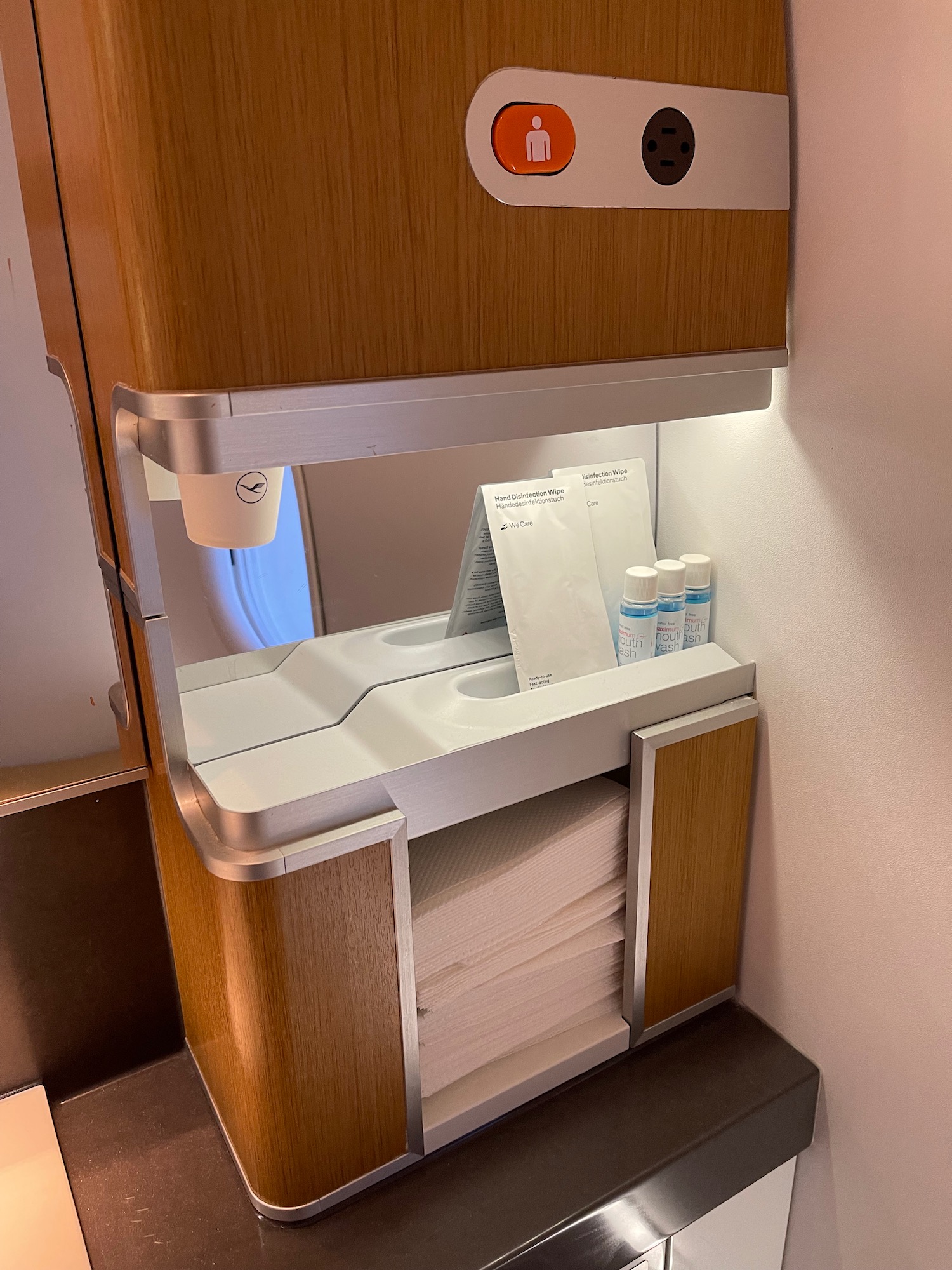 a sink with a shelf full of towels and a paper towel