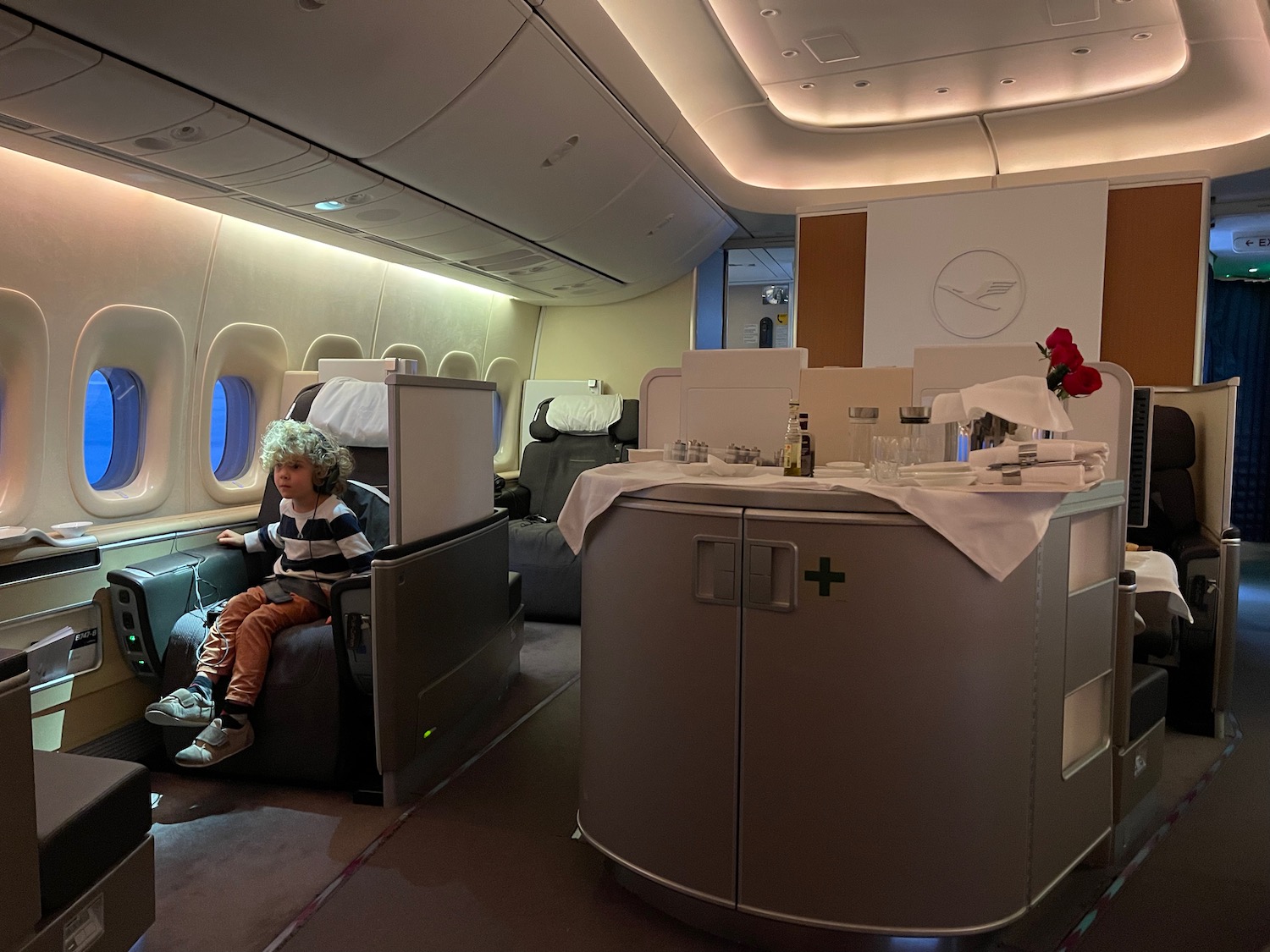 a child sitting in a chair in an airplane