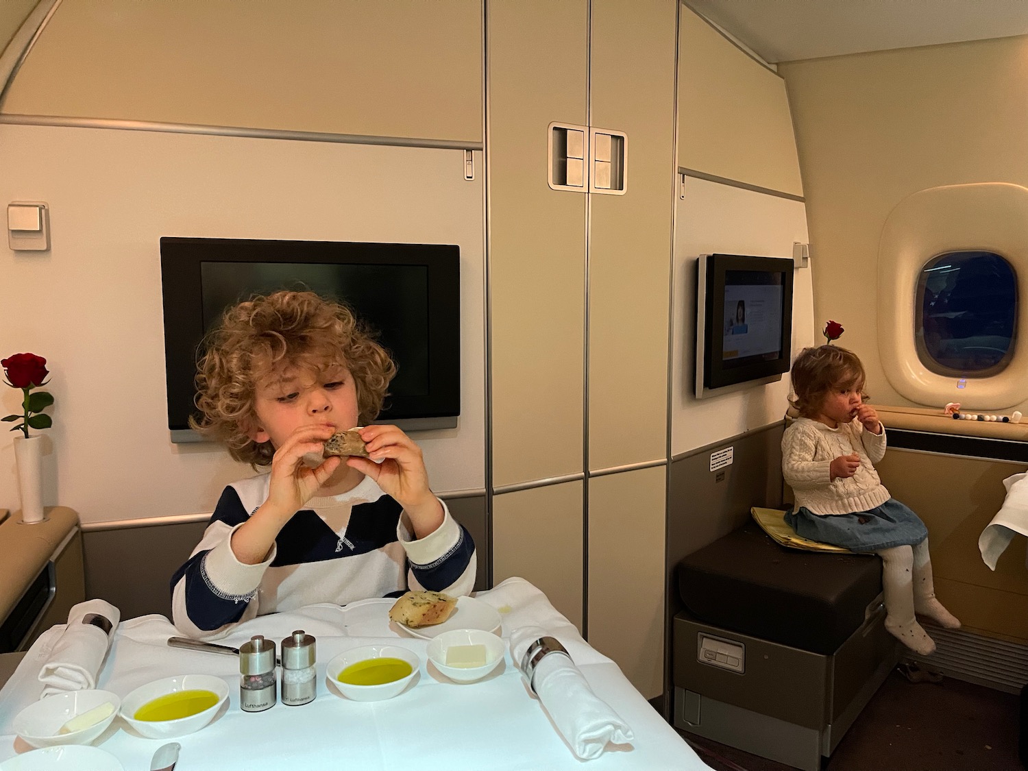 a boy eating food in a plane