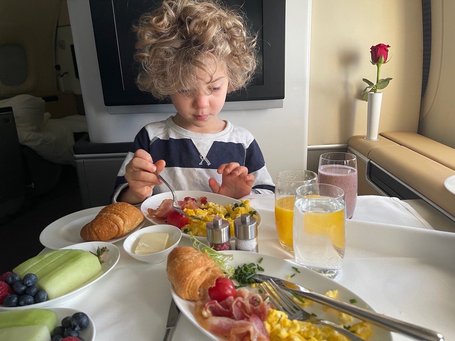 a child eating breakfast at a table