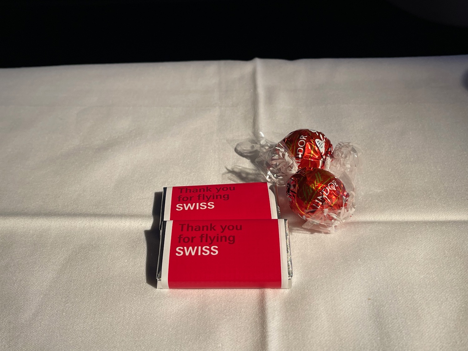 a red and white candy on a white surface