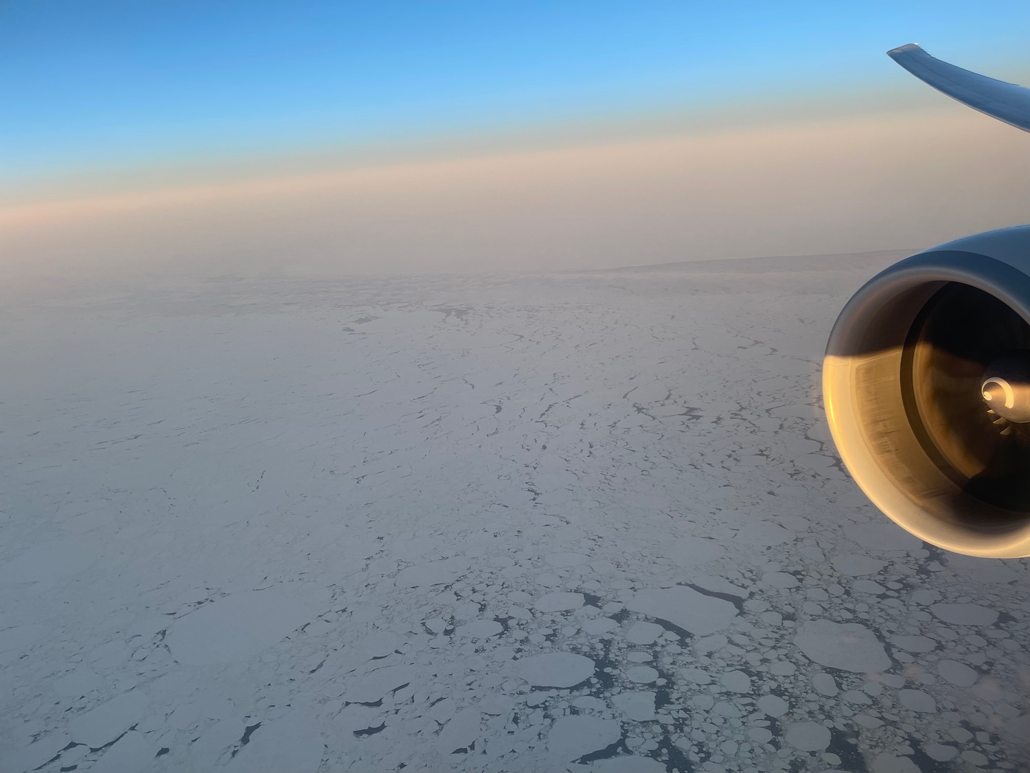 an airplane wing and a snowy landscape