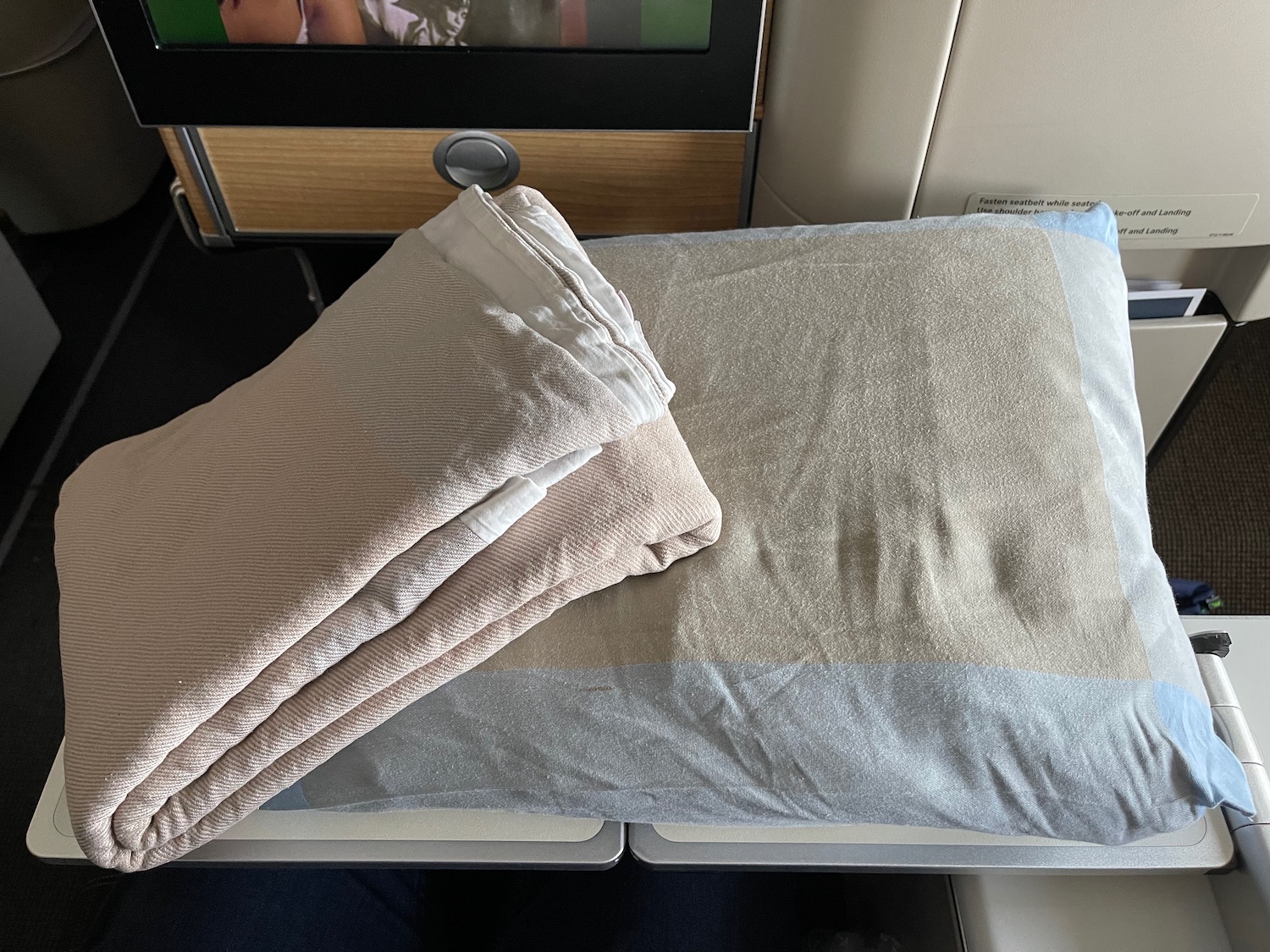 a folded blankets on a bed