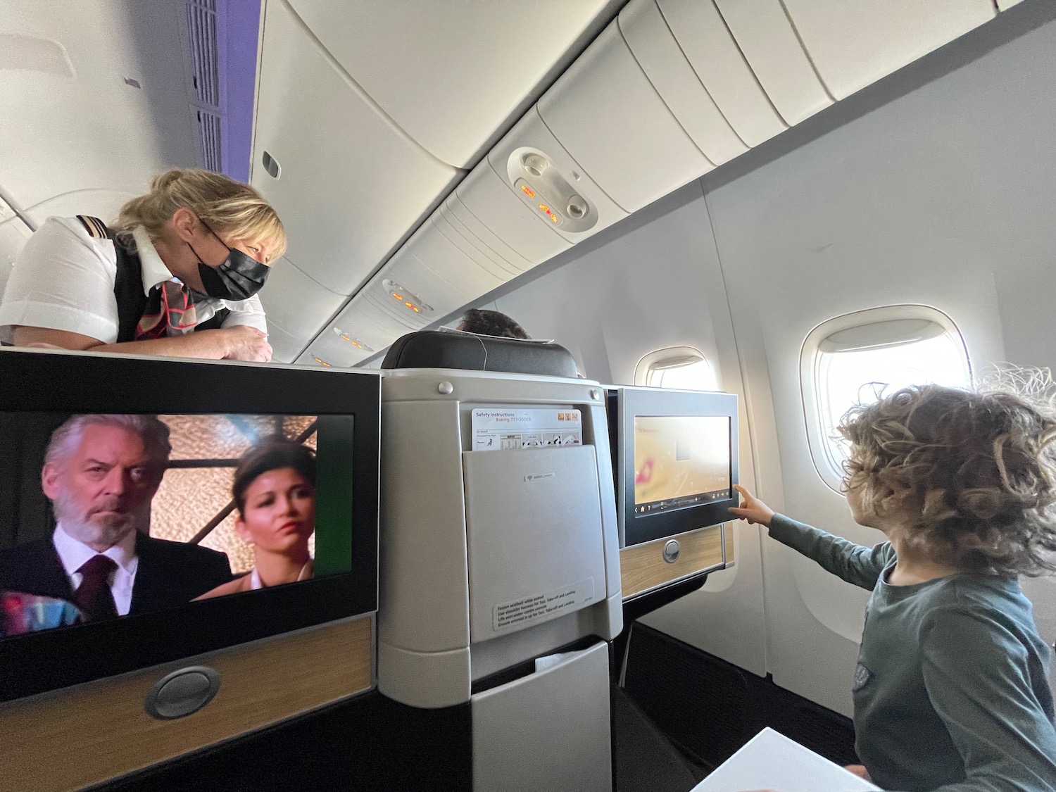 a child looking at a screen on an airplane