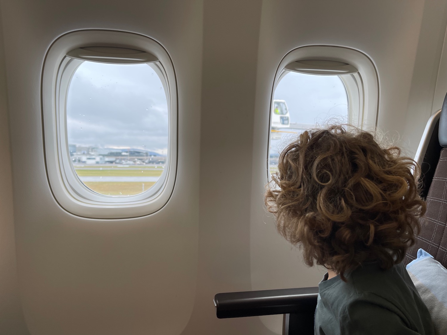 a woman looking out of an airplane window