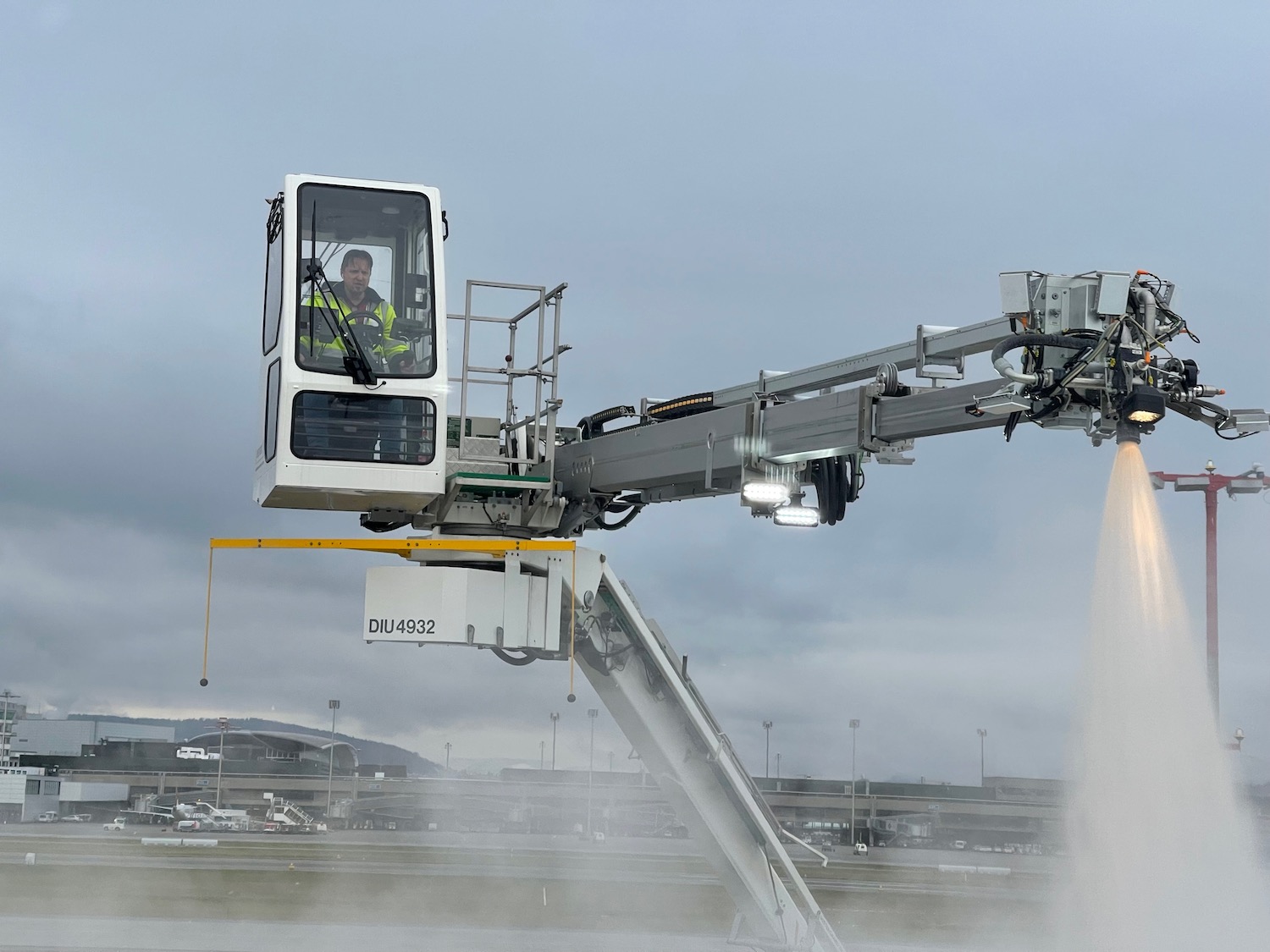 a man in a yellow vest on a crane