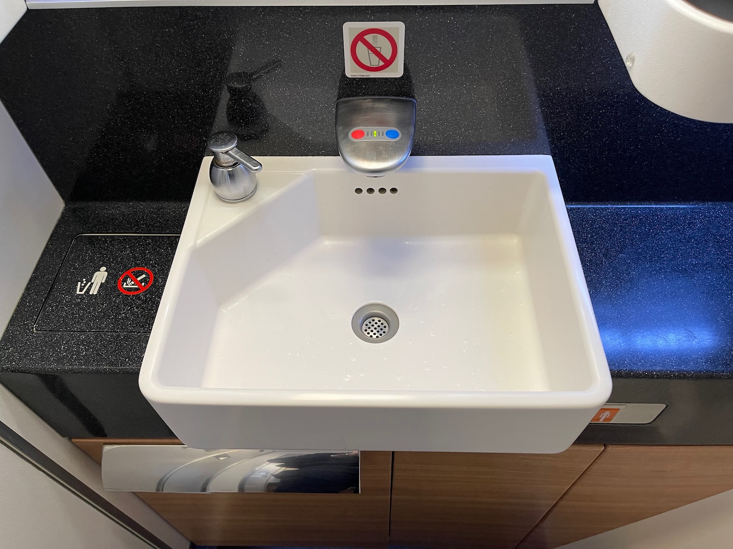 a white sink with a red and blue sign