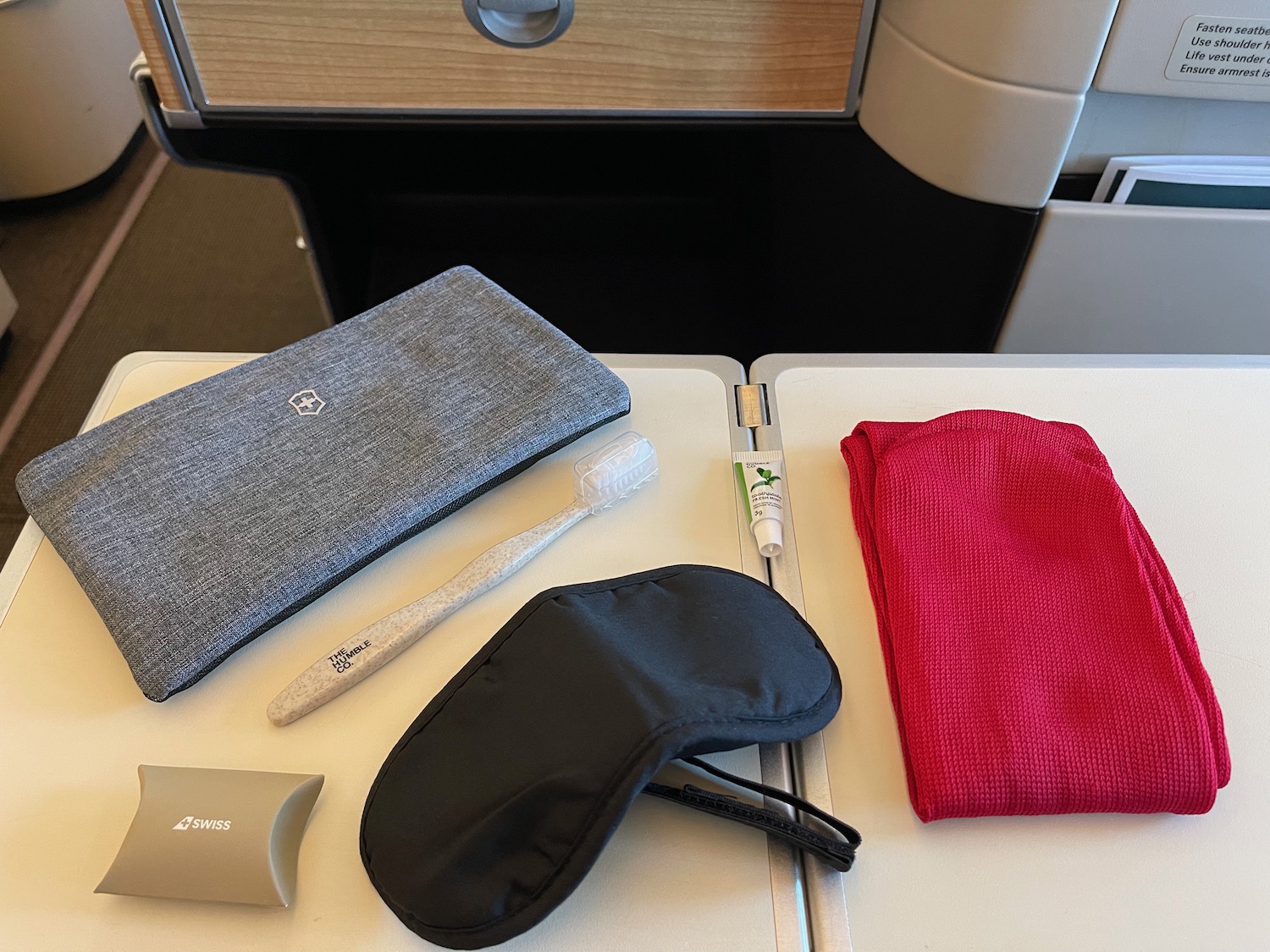 a table with a towel and a toothbrush and a mask on it