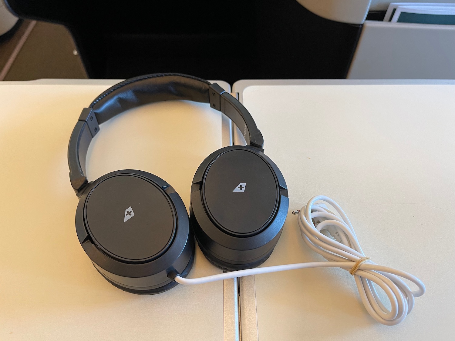a pair of black headphones on a white surface