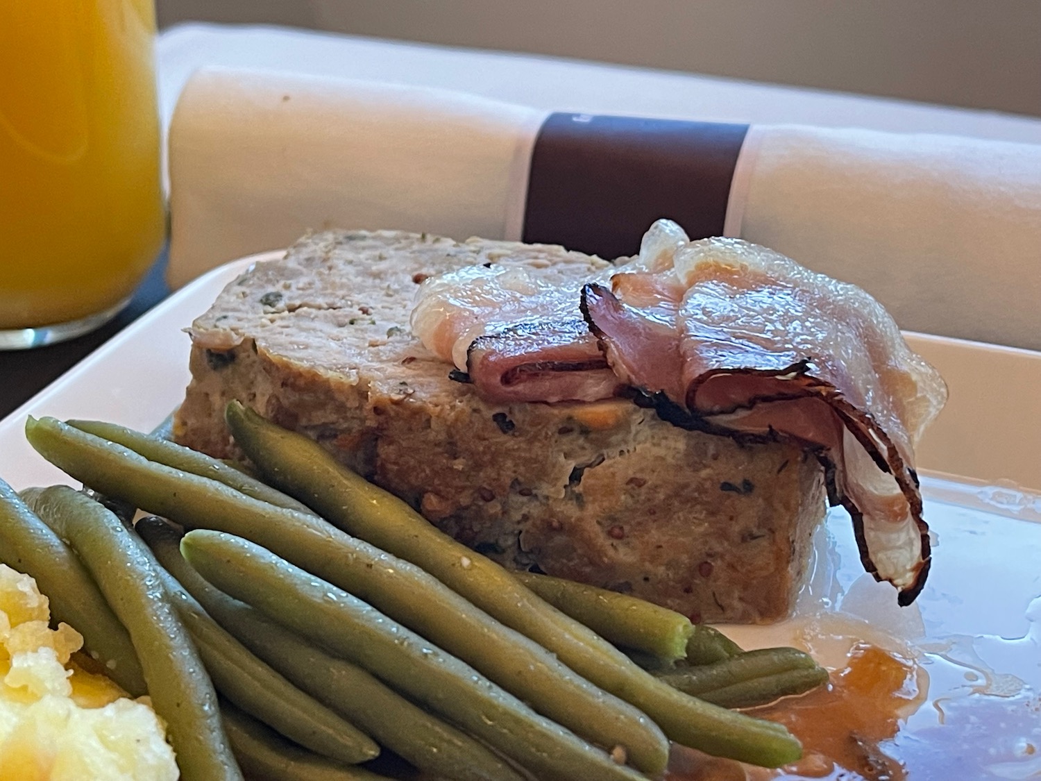 a plate of food with a napkin and a drink