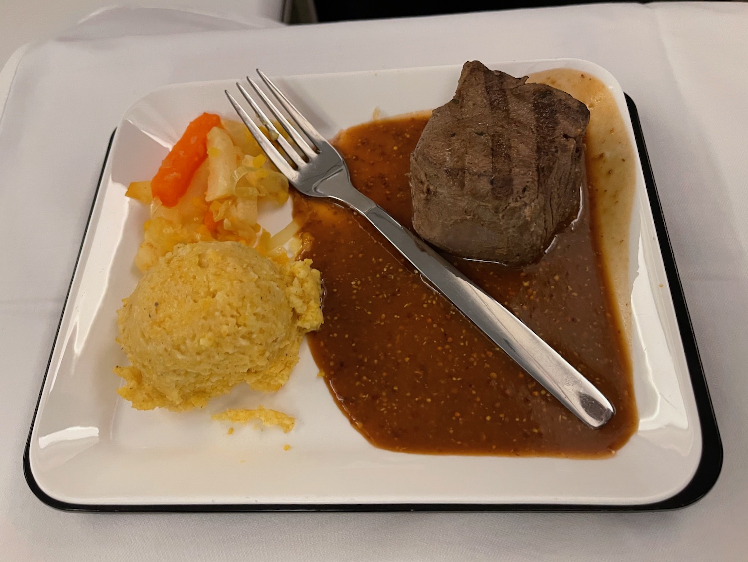 a plate of food with a fork and a knife