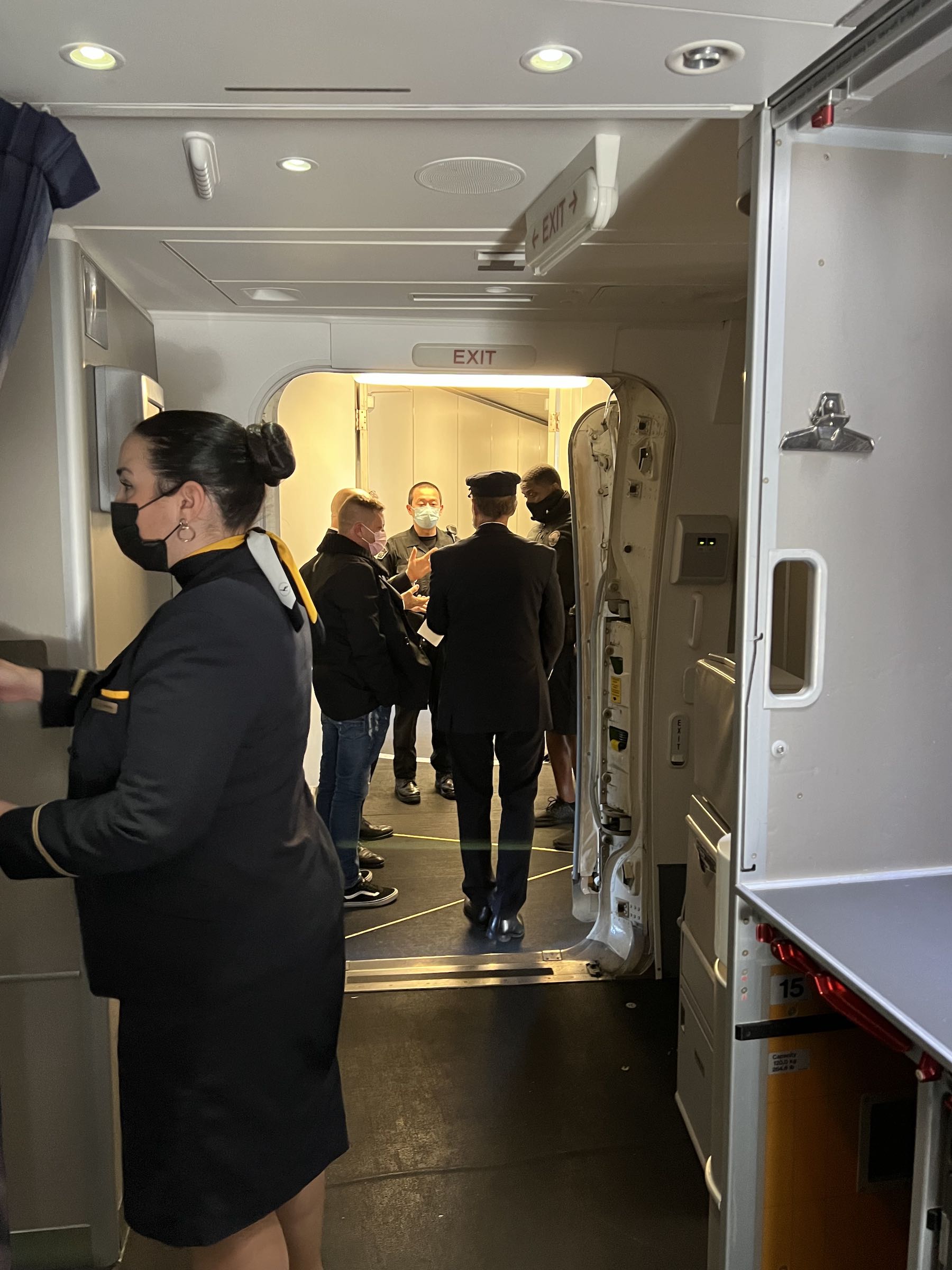 a group of people in a room with a door open