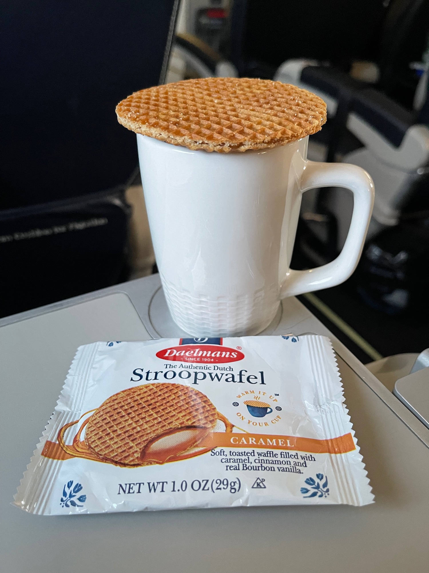 a cup of coffee with a waffle on top