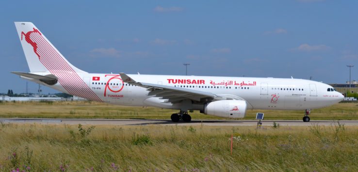 a white airplane on a runway