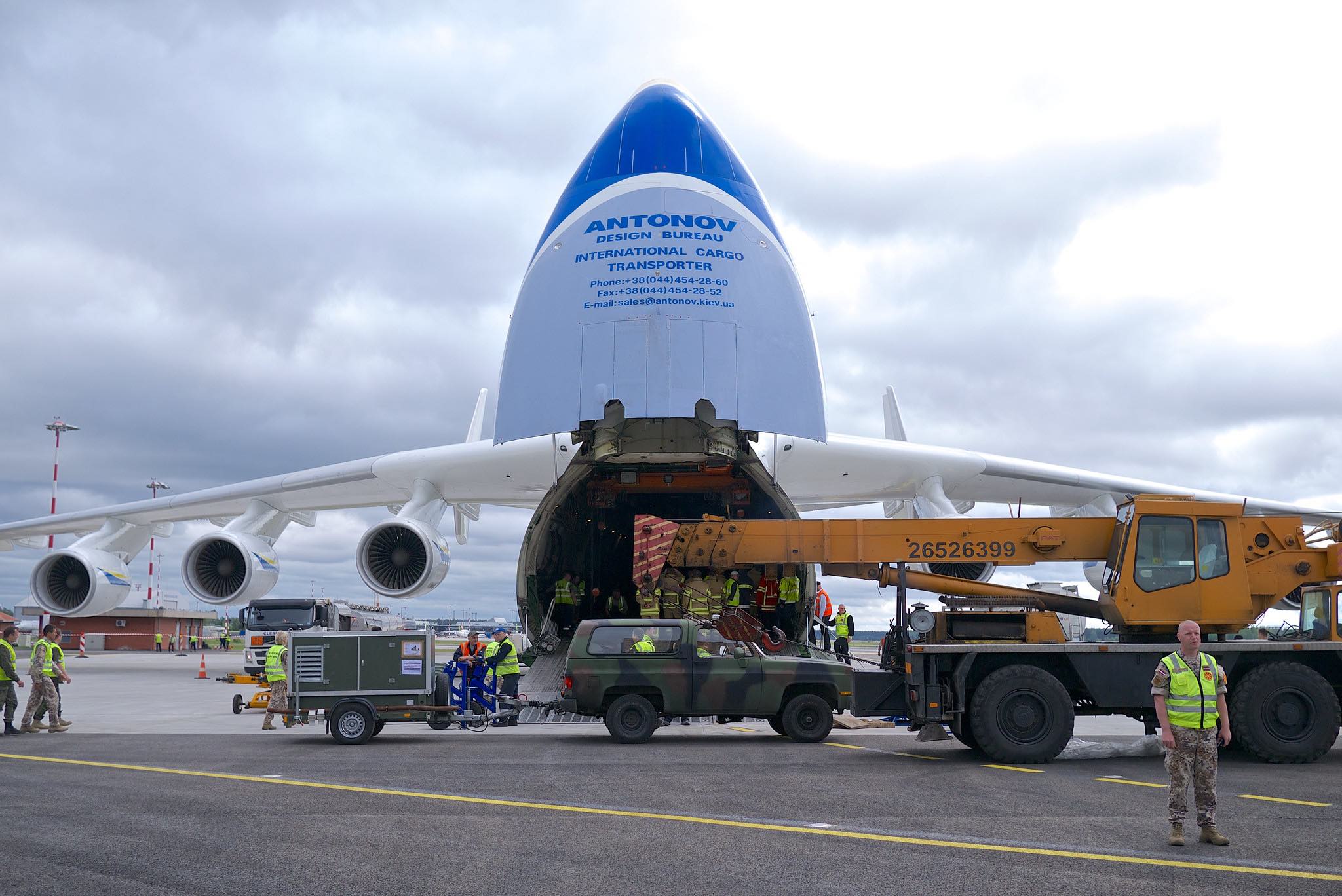 a plane with a truck and people on it