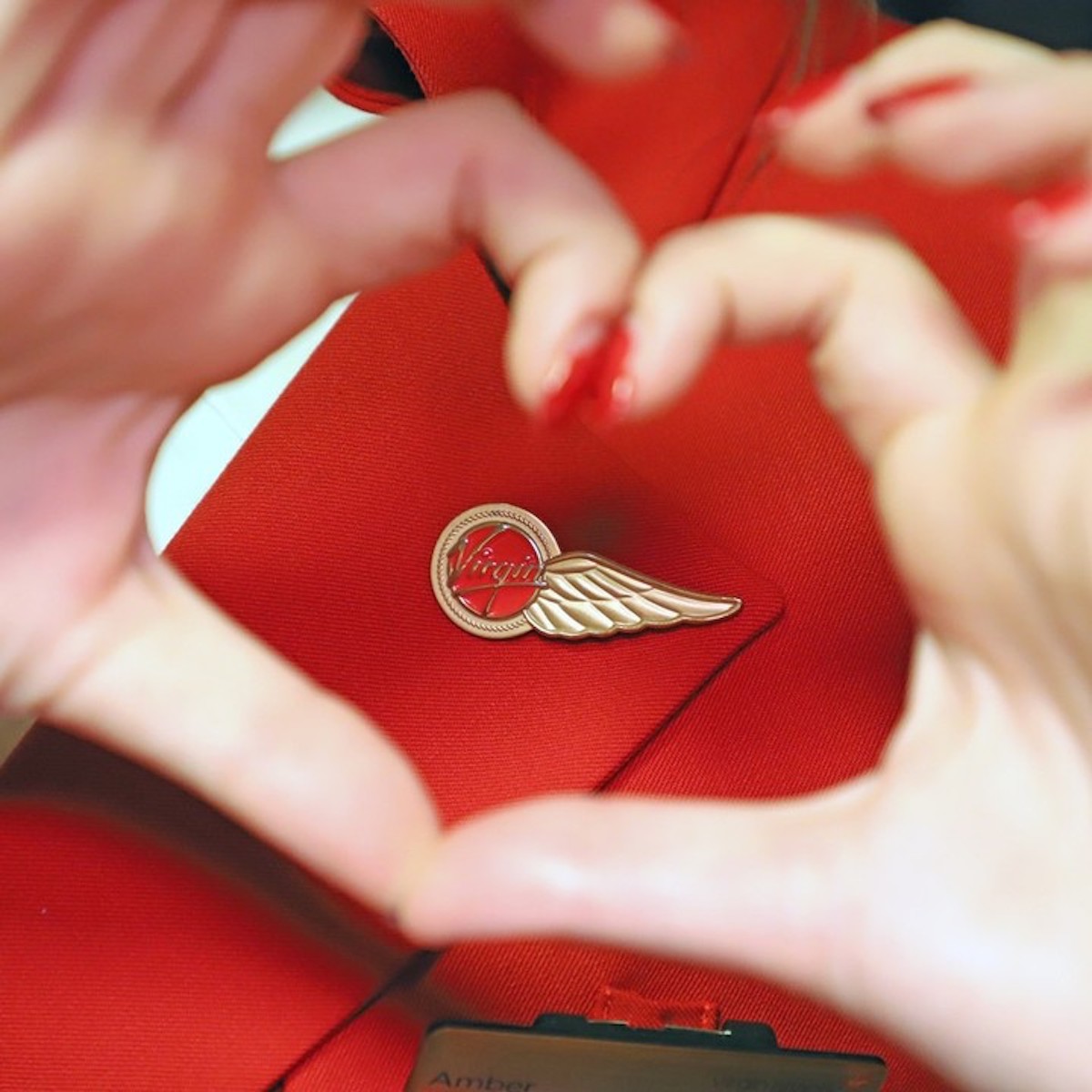 a woman making a heart with her hands
