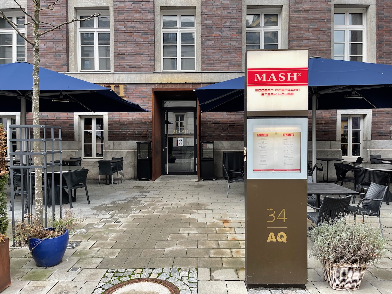 a building with umbrellas and tables and chairs