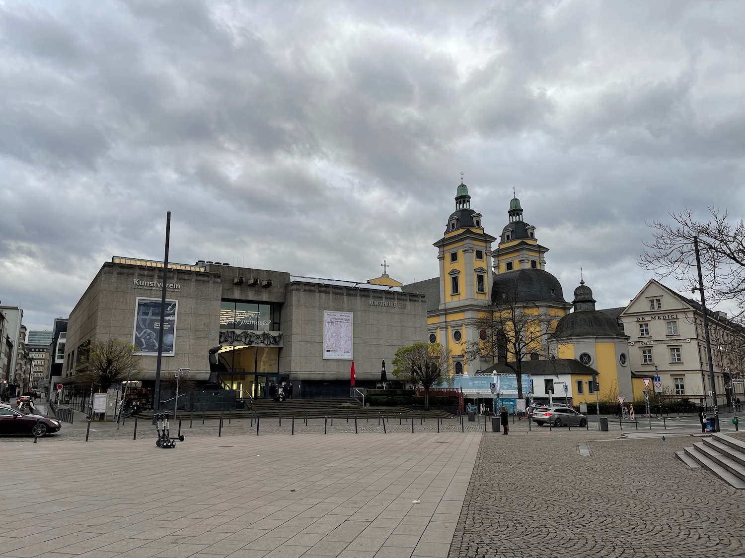 a building with towers and a stone walkway