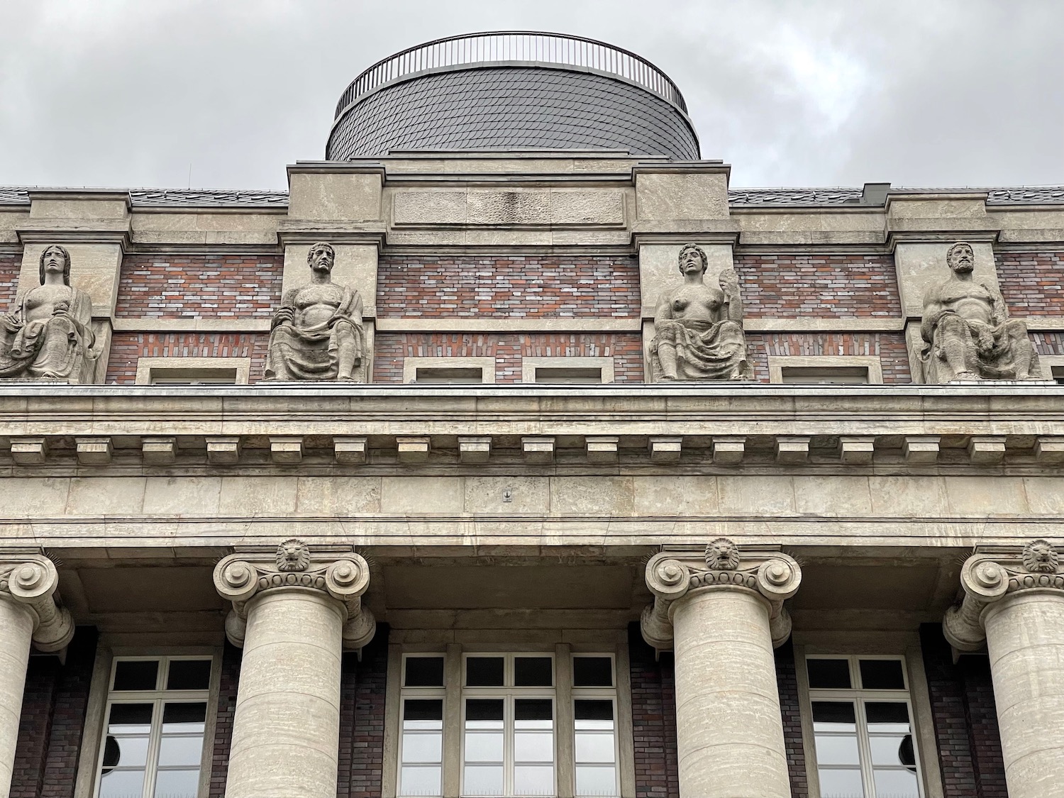 a building with columns and statues on top