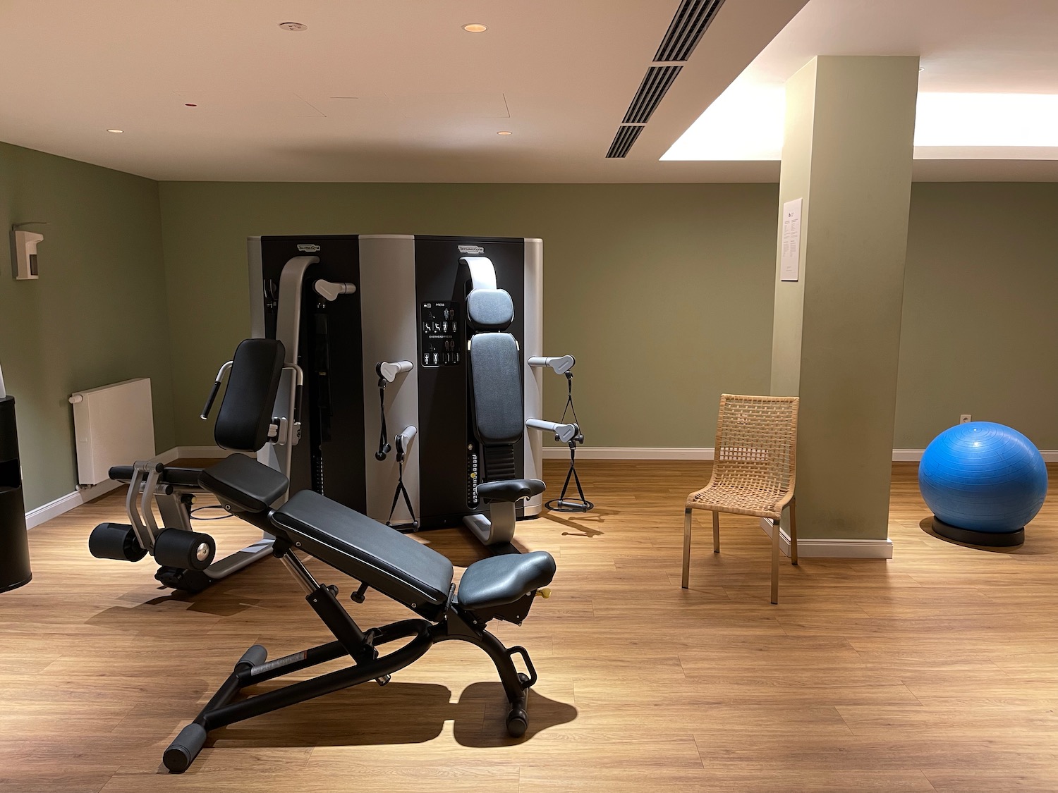 a room with exercise equipment and a chair